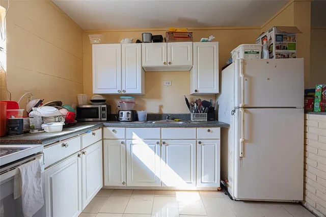 a kitchen with cabinets and white appliances