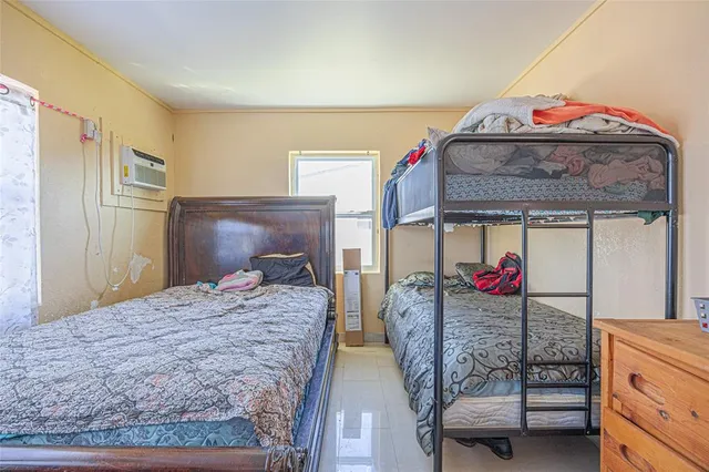 a bedroom with bed and window