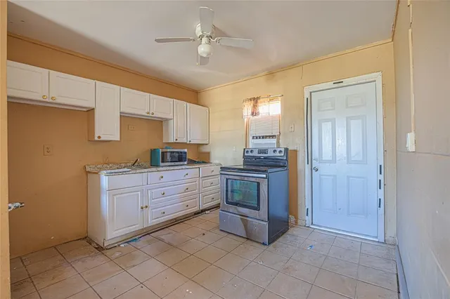 a kitchen with granite countertop cabinets and appliances