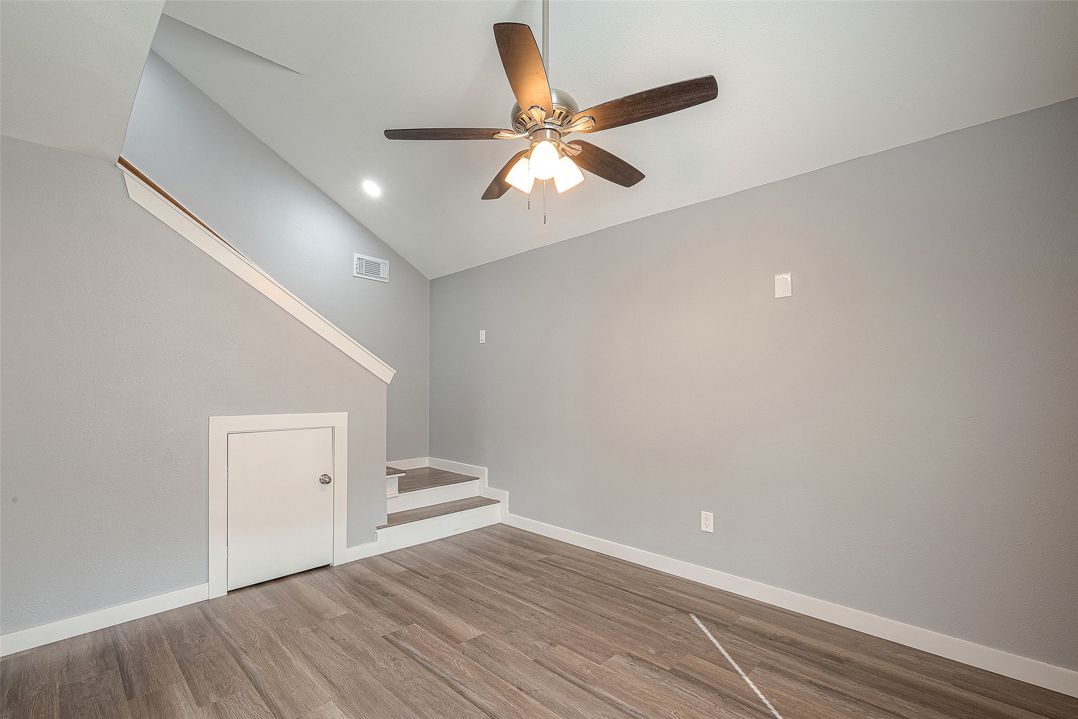 2725 Avenue F, Unit RR Rosenberg, TX 77471 - Photo 17 of 23 wooden floor in an empty room with a window