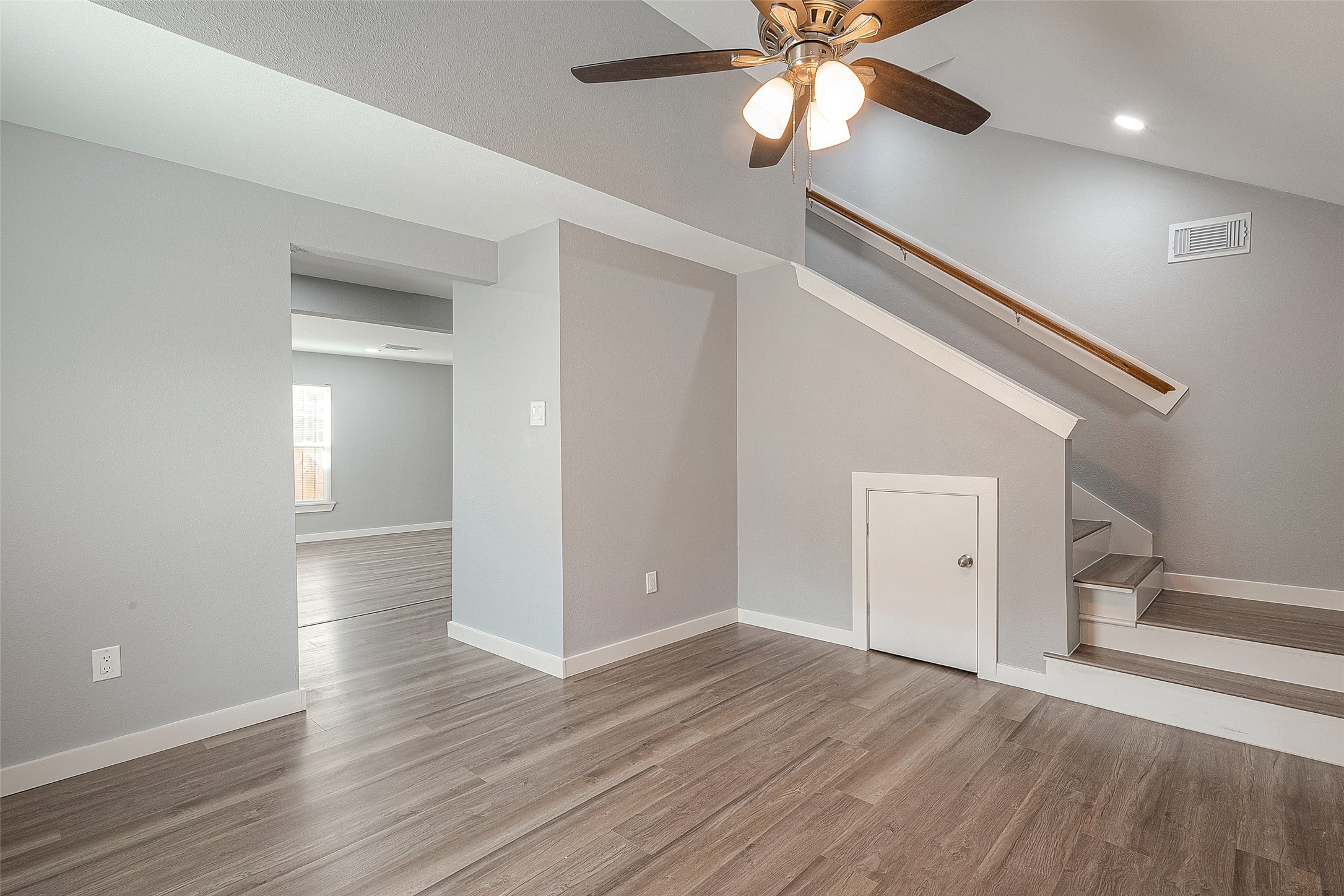 2725 Avenue F, Unit RR Rosenberg, TX 77471 - Photo 18 of 23 wooden floor in an empty room with a window