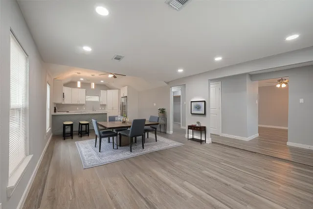 a view of a dining room with furniture and wooden floor