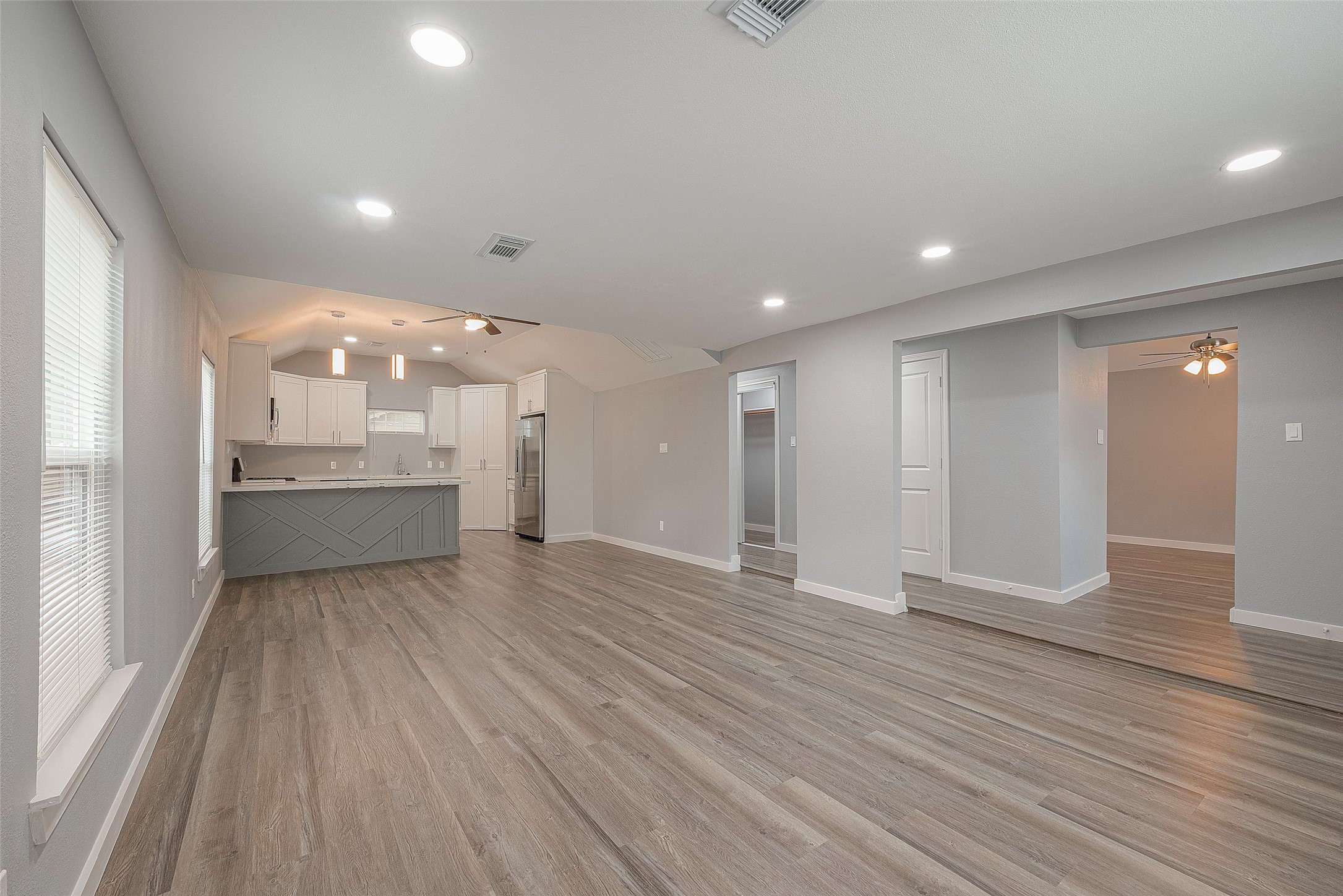 2725 Avenue F, Unit RR Rosenberg, TX 77471 - Photo 7 of 23 a view of a big room with wooden floor and windows