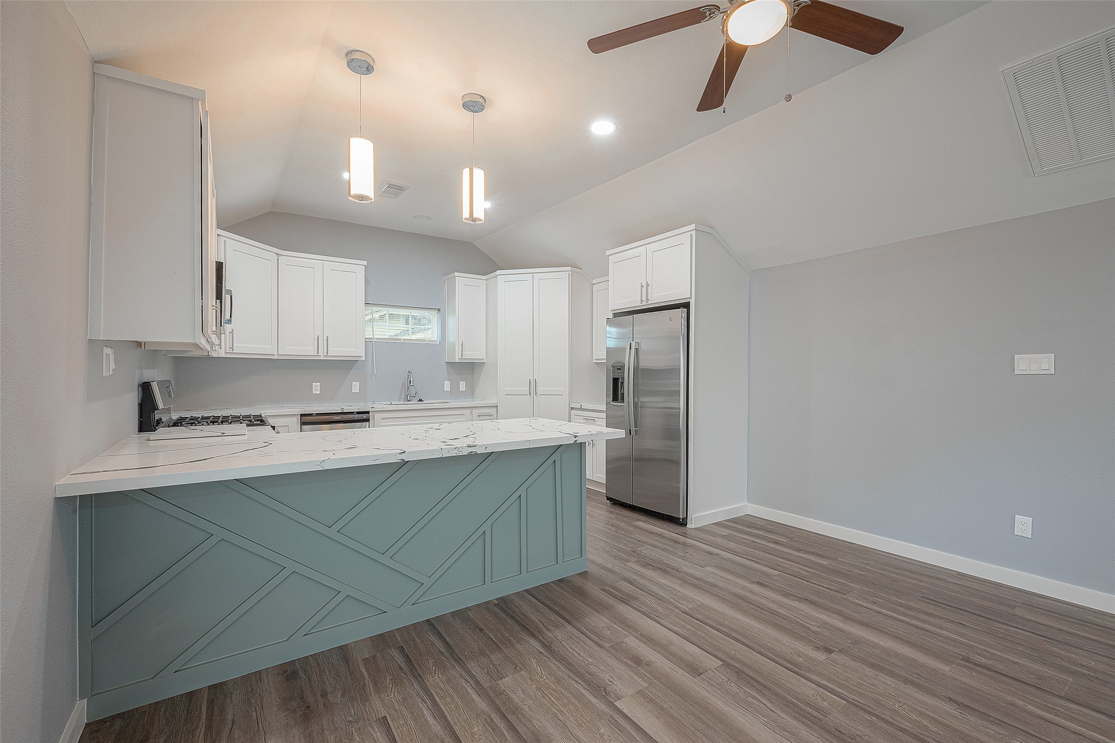 2725 Avenue F, Unit RR Rosenberg, TX 77471 - Photo 10 of 23 a kitchen with stainless steel appliances a sink cabinets and wooden floor