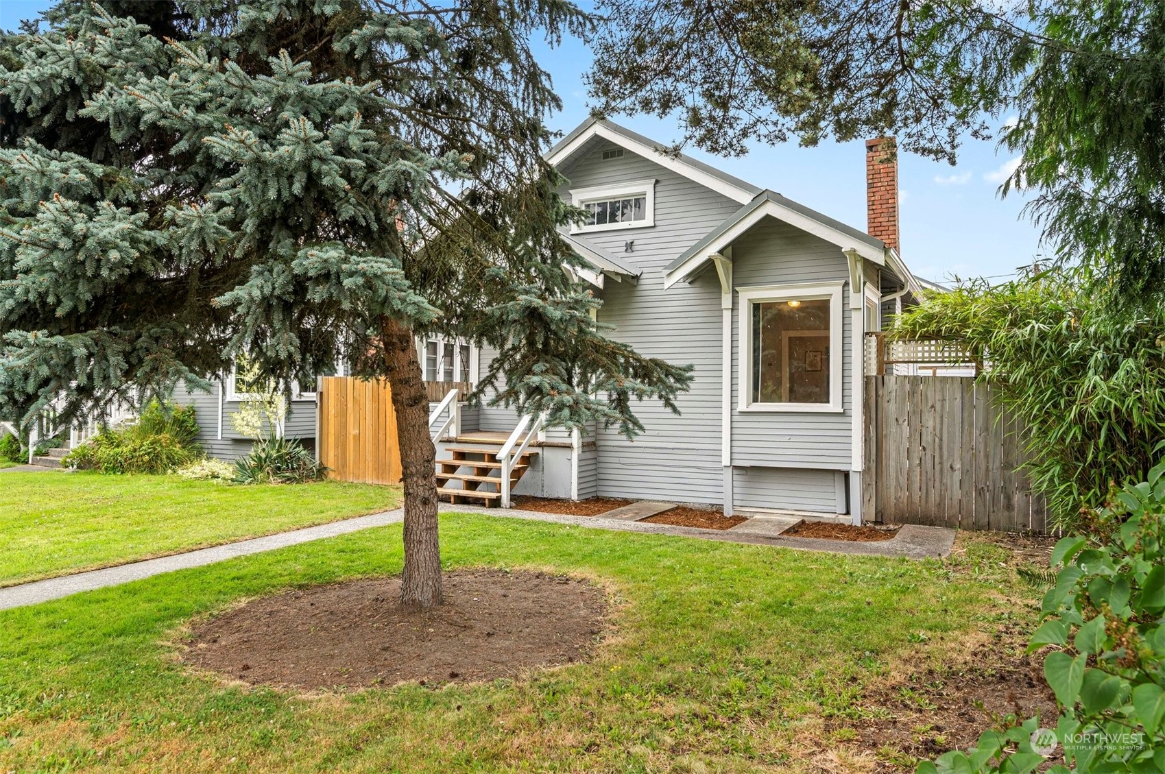3015 21st Street Everett, WA 98201 - Photo 3 of 26 a front view of a house with garden