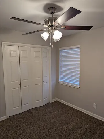 a view of a chandelier fan and a window