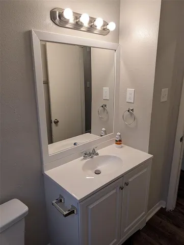 a bathroom with a sink vanity and a mirror