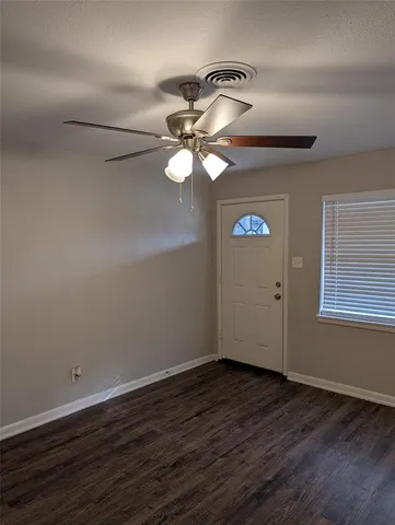 a view of a room with wooden floor