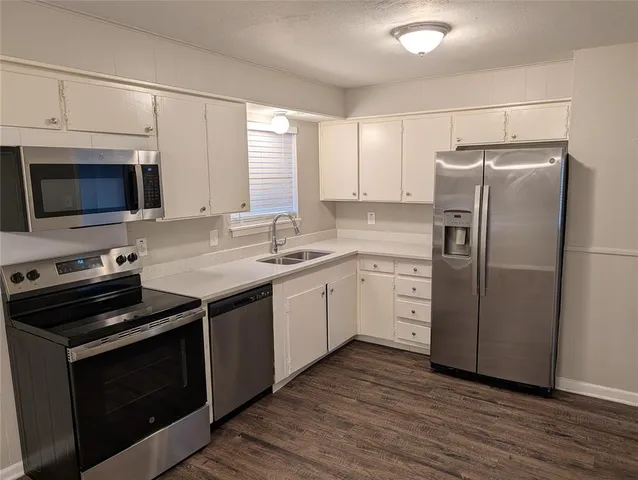 a kitchen with a stove microwave and a refrigerator