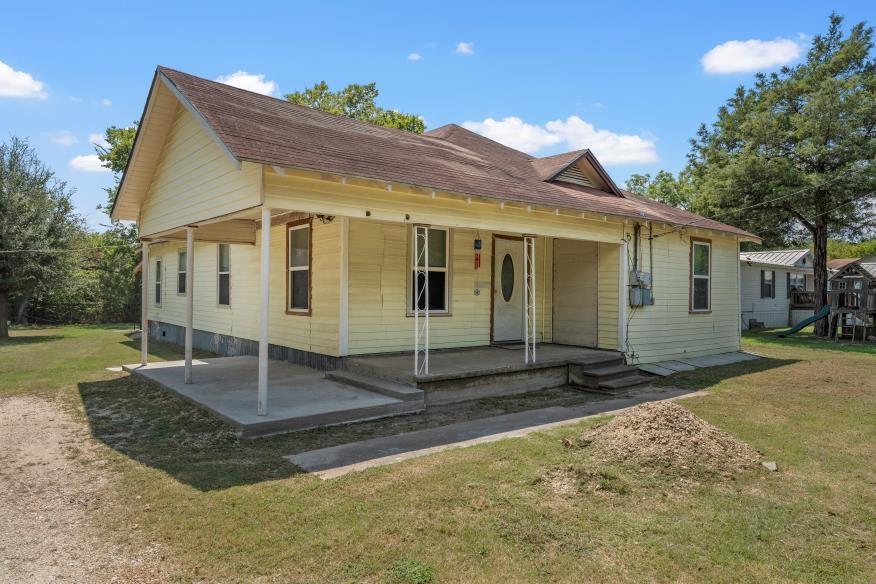 400 East Travis Street Mexia, TX 76667 - Photo 2 of 16 a view of a house with backyard