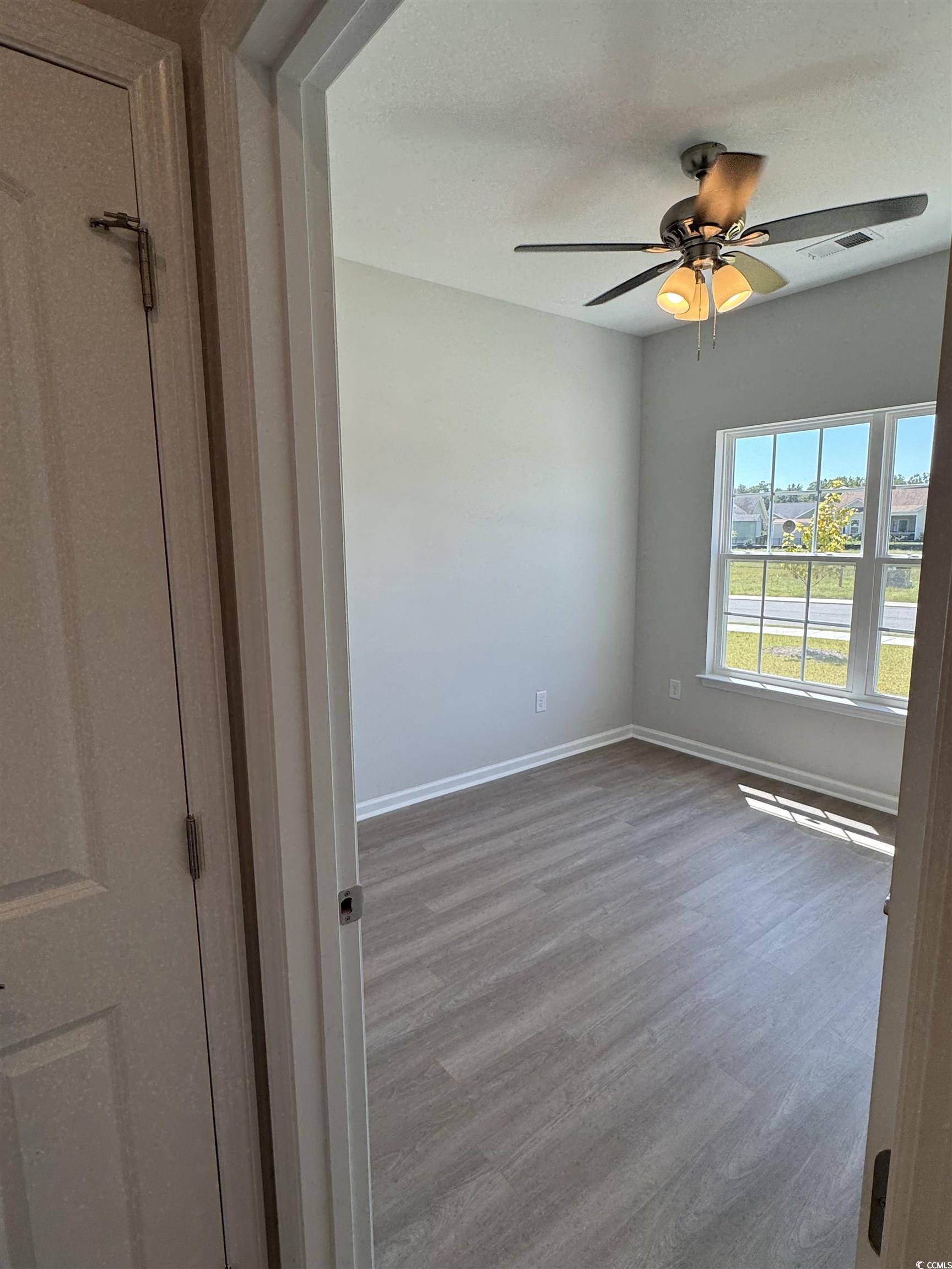 598 Shallow Cv Drive Conway, SC 29527 - Photo 16 of 25 Spare room featuring wood finished floors and a ce