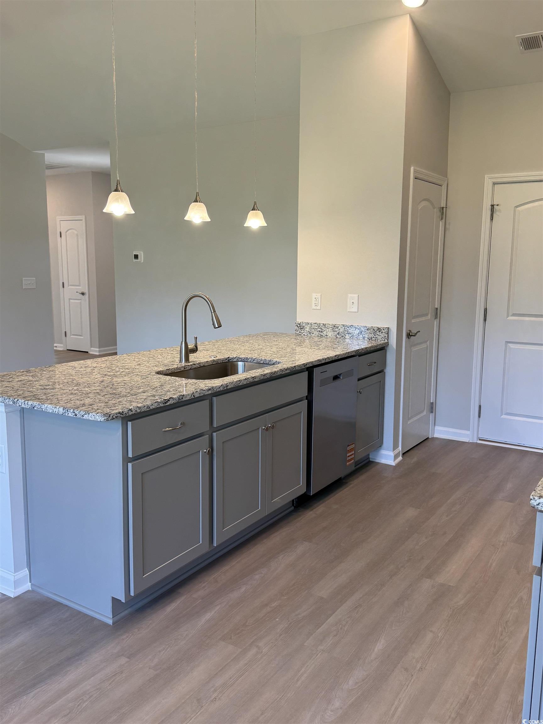 598 Shallow Cv Drive Conway, SC 29527 - Photo 9 of 25 Kitchen with gray cabinets, light stone countertop