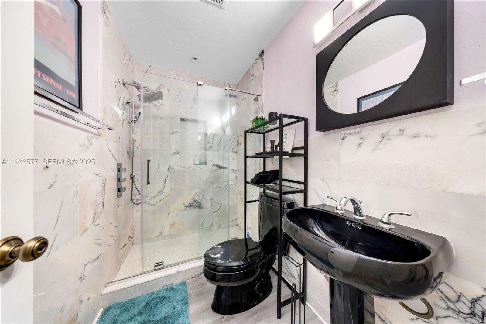 1840 Tigertail Avenue Miami, FL 33133 - Photo 12 of 32 a bathroom with a sink a toilet and a mirror