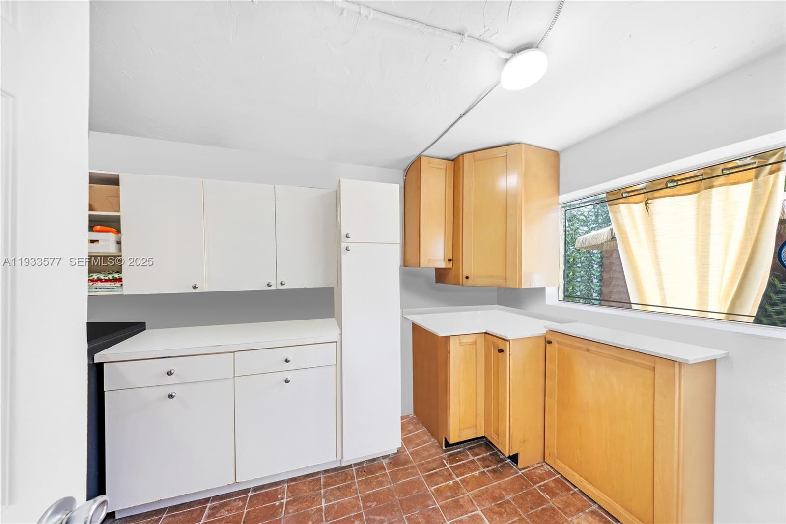 1840 Tigertail Avenue Miami, FL 33133 - Photo 24 of 32 a view of kitchen with wooden floor and window