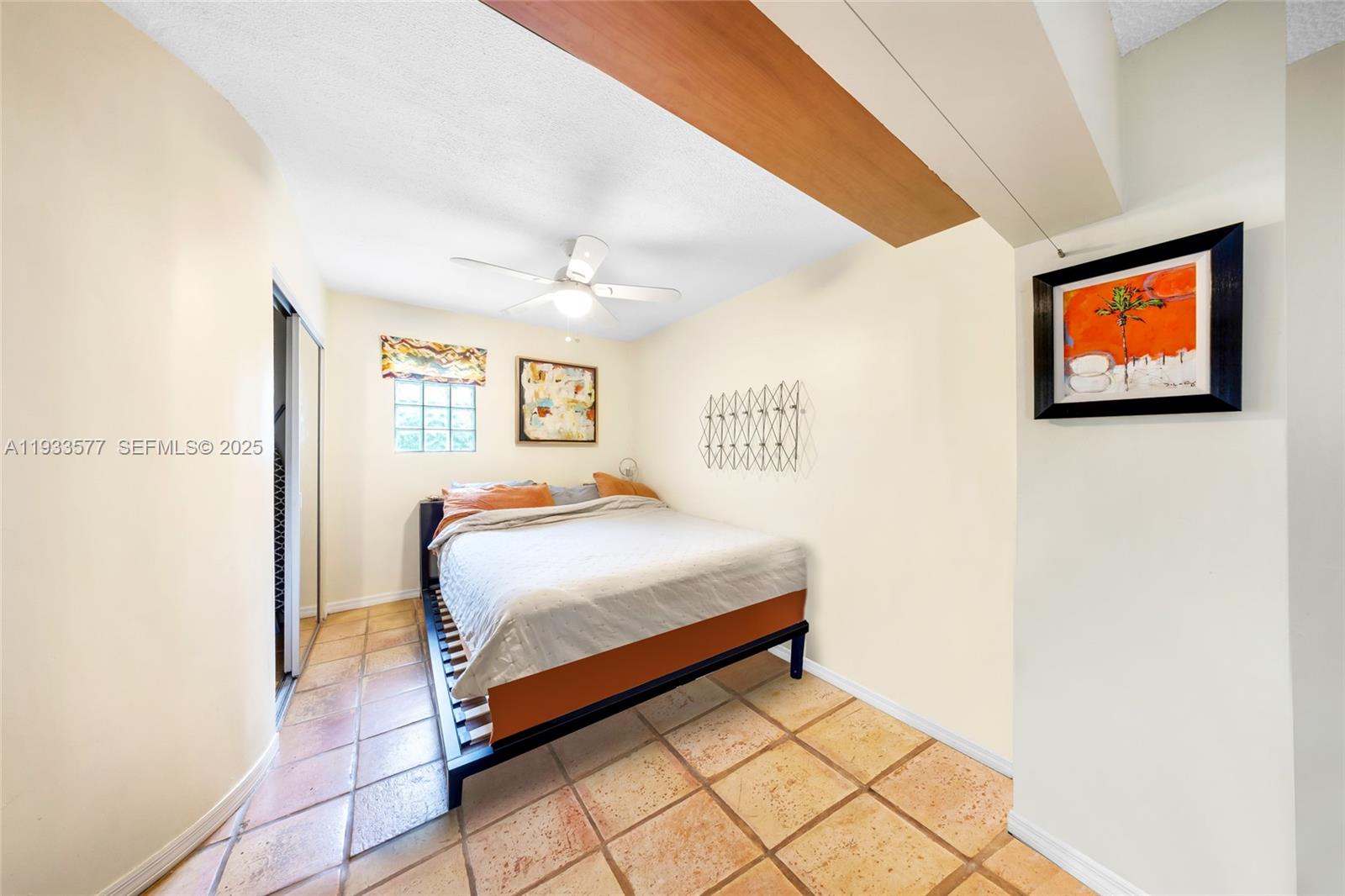 1840 Tigertail Avenue Miami, FL 33133 - Photo 26 of 32 a bedroom with a bed and a painting on the wall