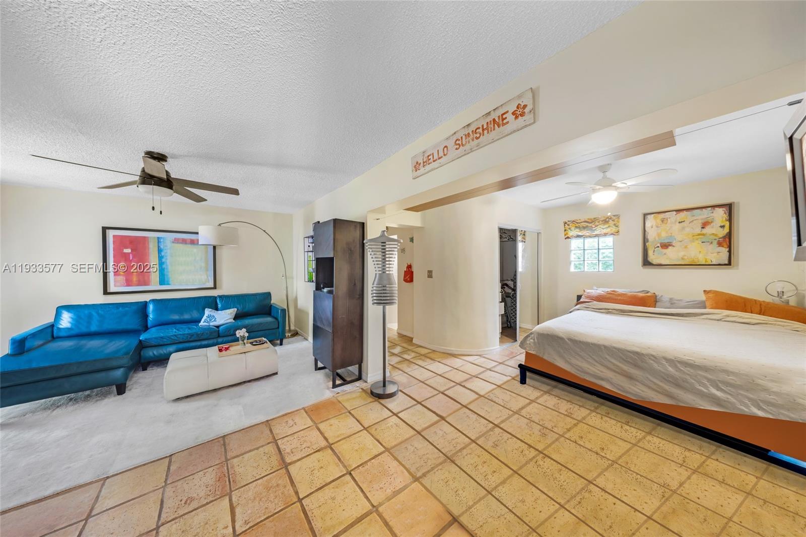 1840 Tigertail Avenue Miami, FL 33133 - Photo 28 of 32 a spacious bedroom with a bed a couch and a walk in closet