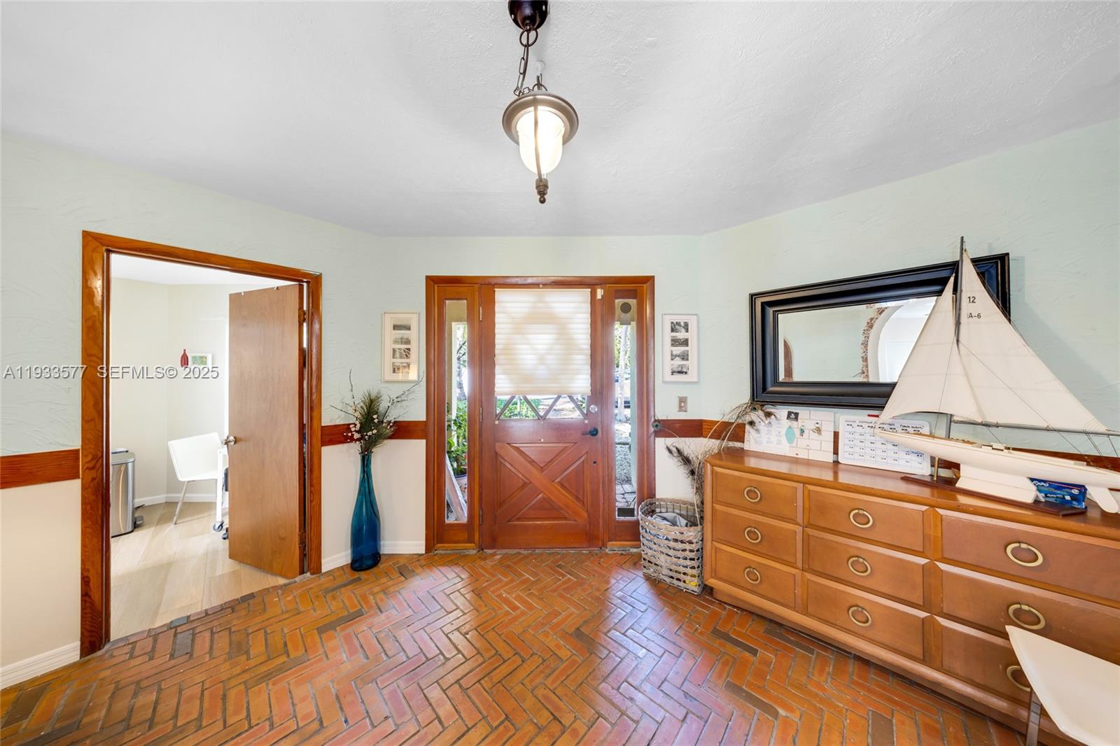 1840 Tigertail Avenue Miami, FL 33133 - Photo 7 of 32 a bedroom with a bed and a chandelier