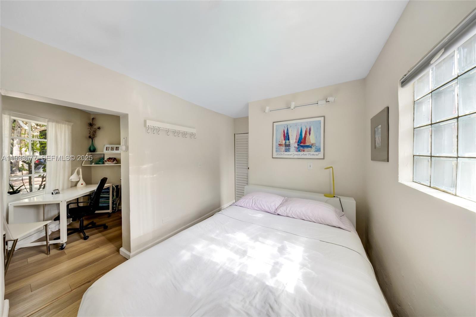 1840 Tigertail Avenue Miami, FL 33133 - Photo 9 of 32 a bedroom with a bed and a table in it