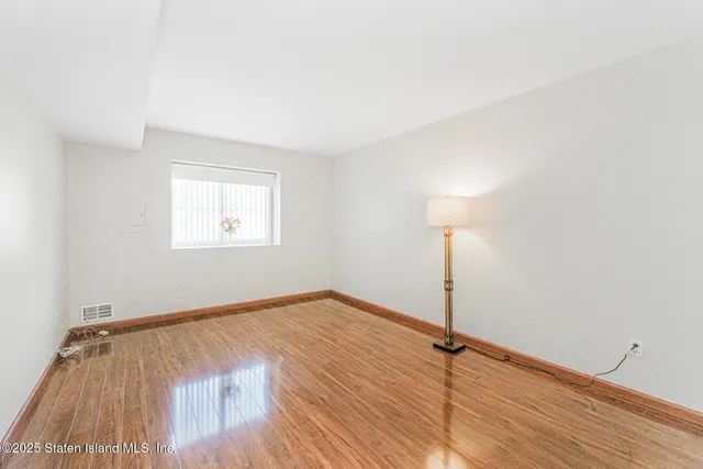 a view of a room with wooden floor and fan