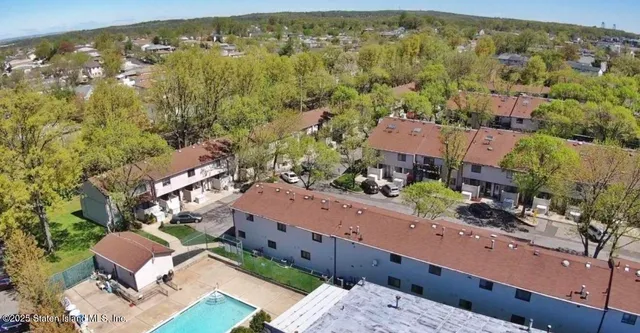 an aerial view of residential houses with outdoor space