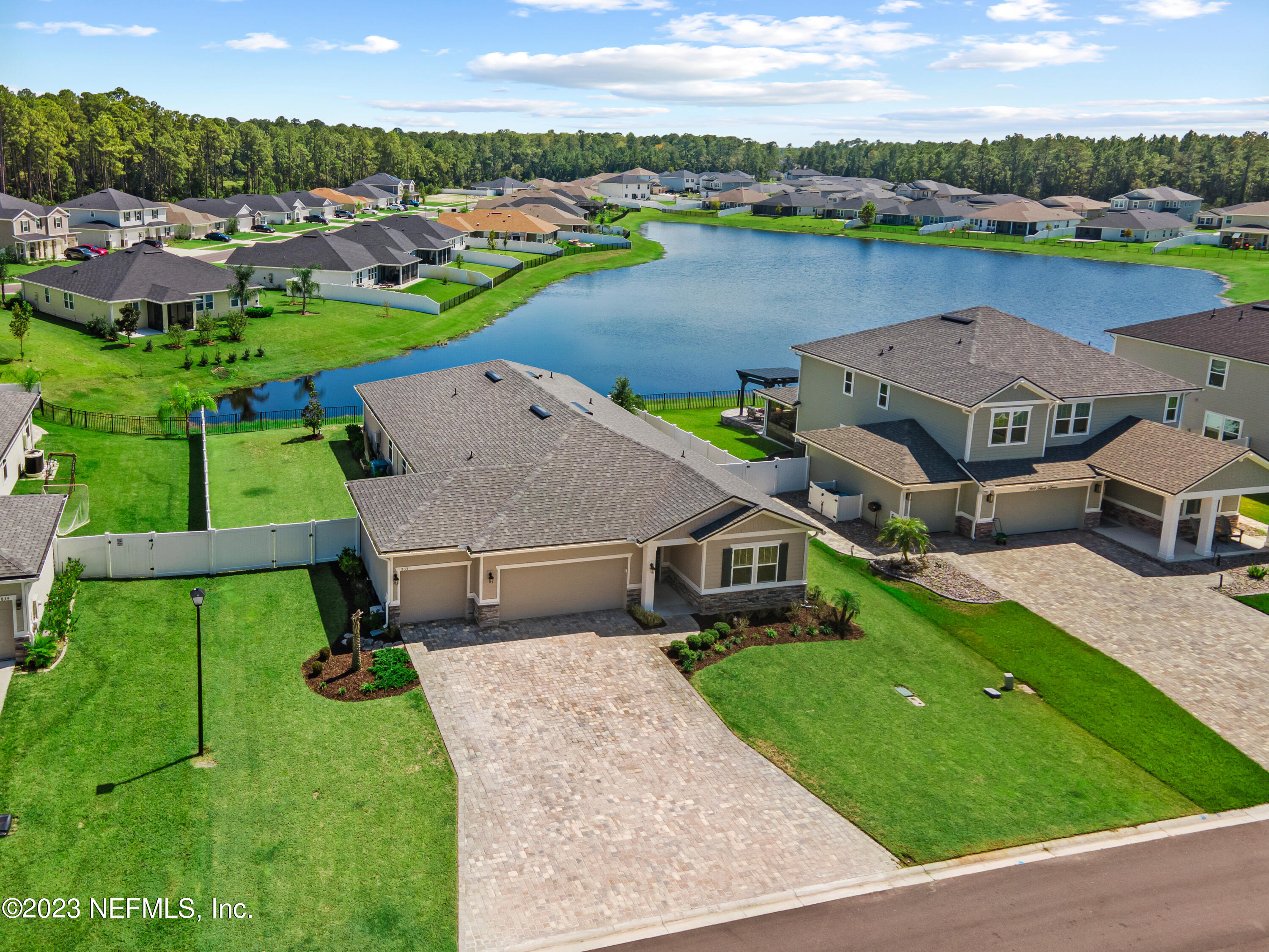 an aerial view of a house with outdoor space and lake view