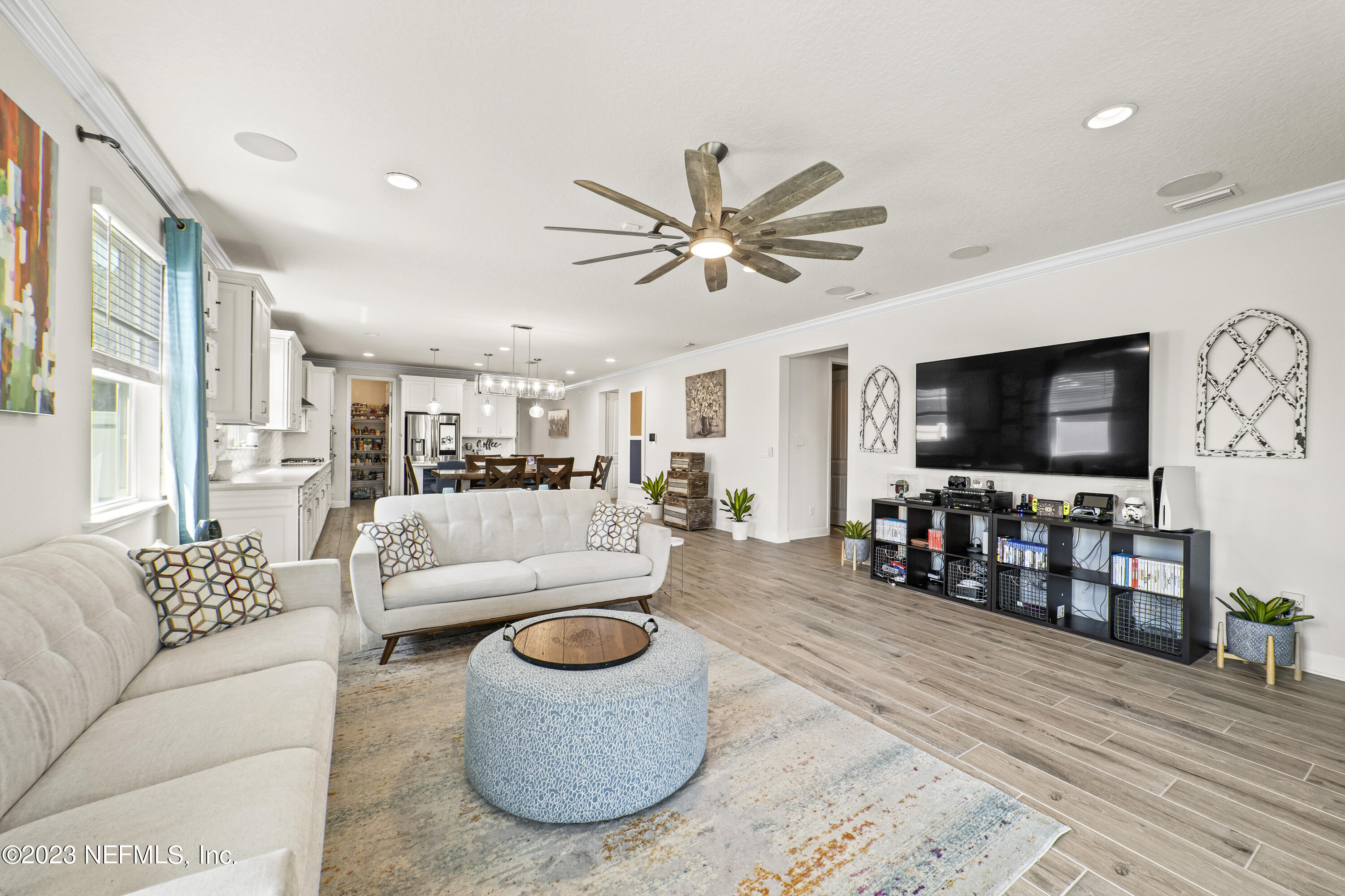 855 Flach Drive St. Johns, FL 32259 - Photo 18 of 50 a living room with furniture a flat screen tv and a large window