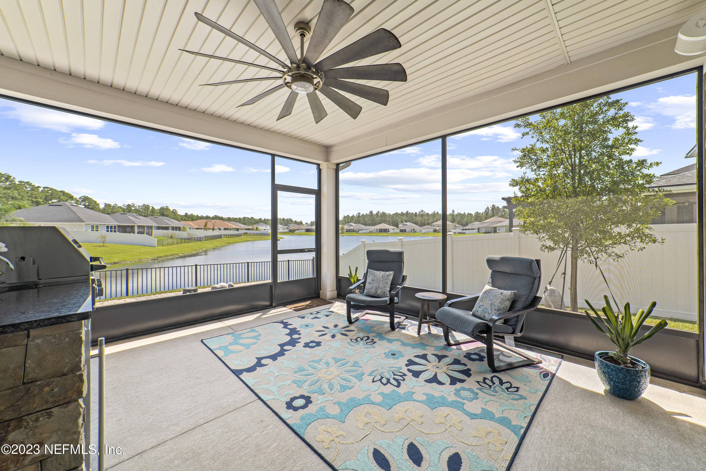 855 Flach Drive St. Johns, FL 32259 - Photo 19 of 50 a living room with furniture and floor to ceiling windows