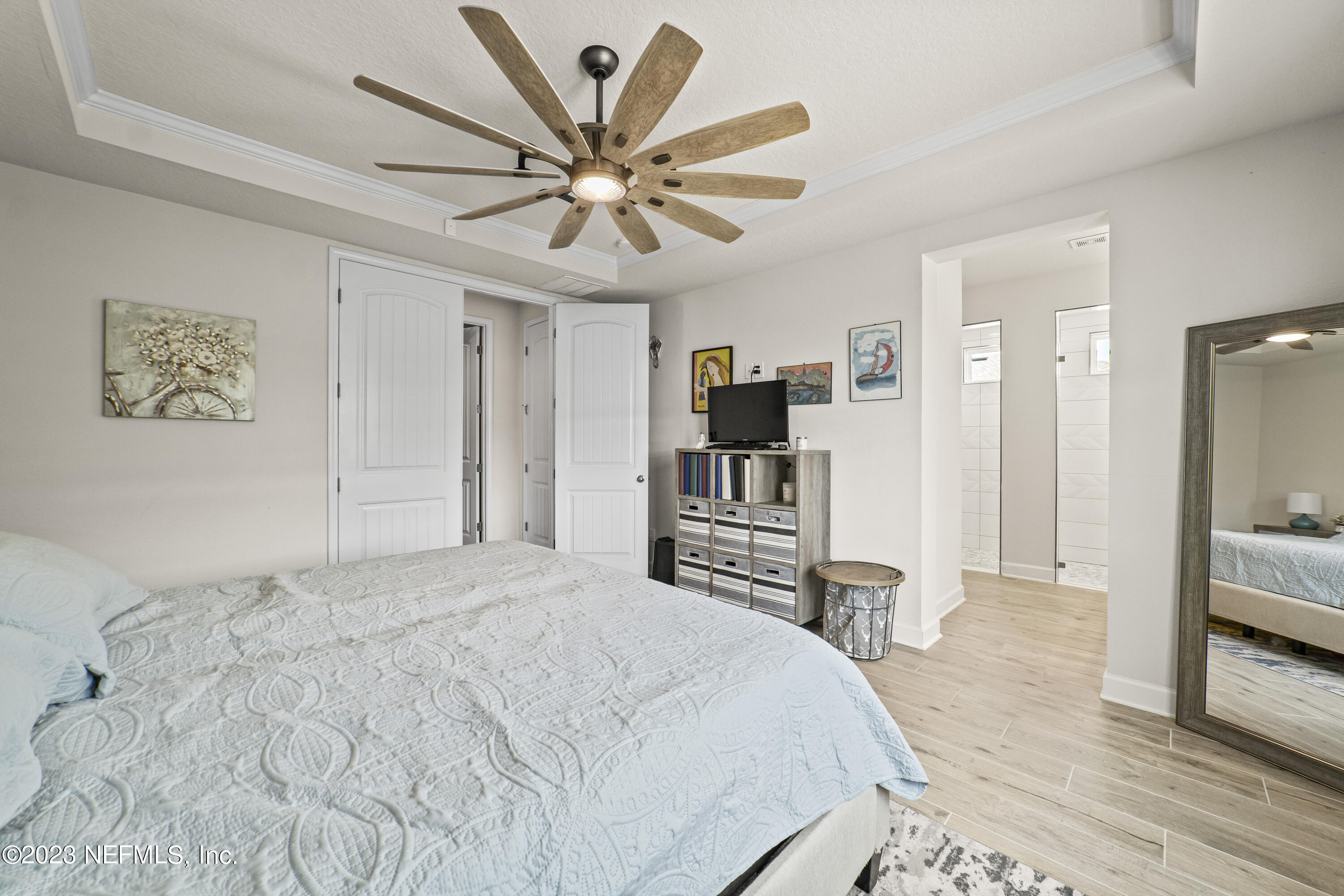 855 Flach Drive St. Johns, FL 32259 - Photo 23 of 50 a bedroom with a bed and a chandelier