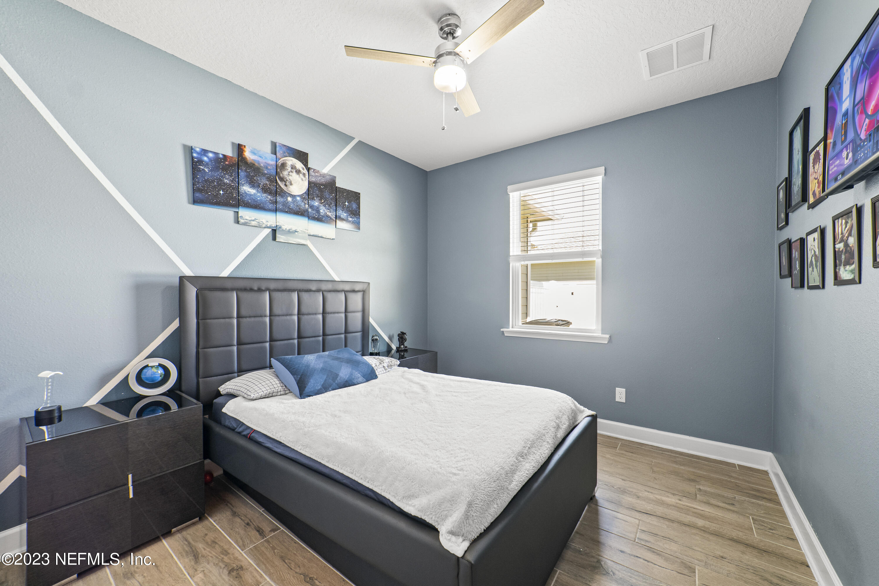 855 Flach Drive St. Johns, FL 32259 - Photo 37 of 50 a bedroom with a bed a dresser and book shelf