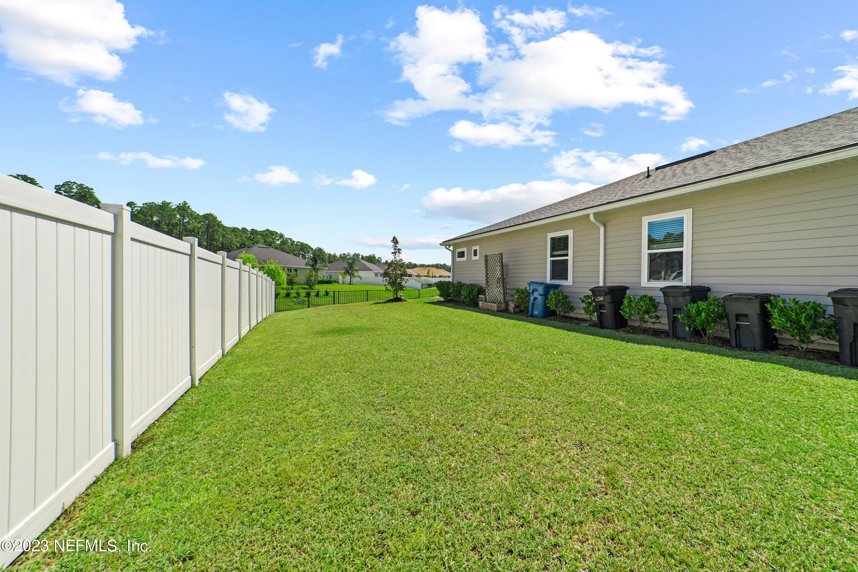 855 Flach Drive St. Johns, FL 32259 - Photo 43 of 50 a view of a backyard with plants and a garden