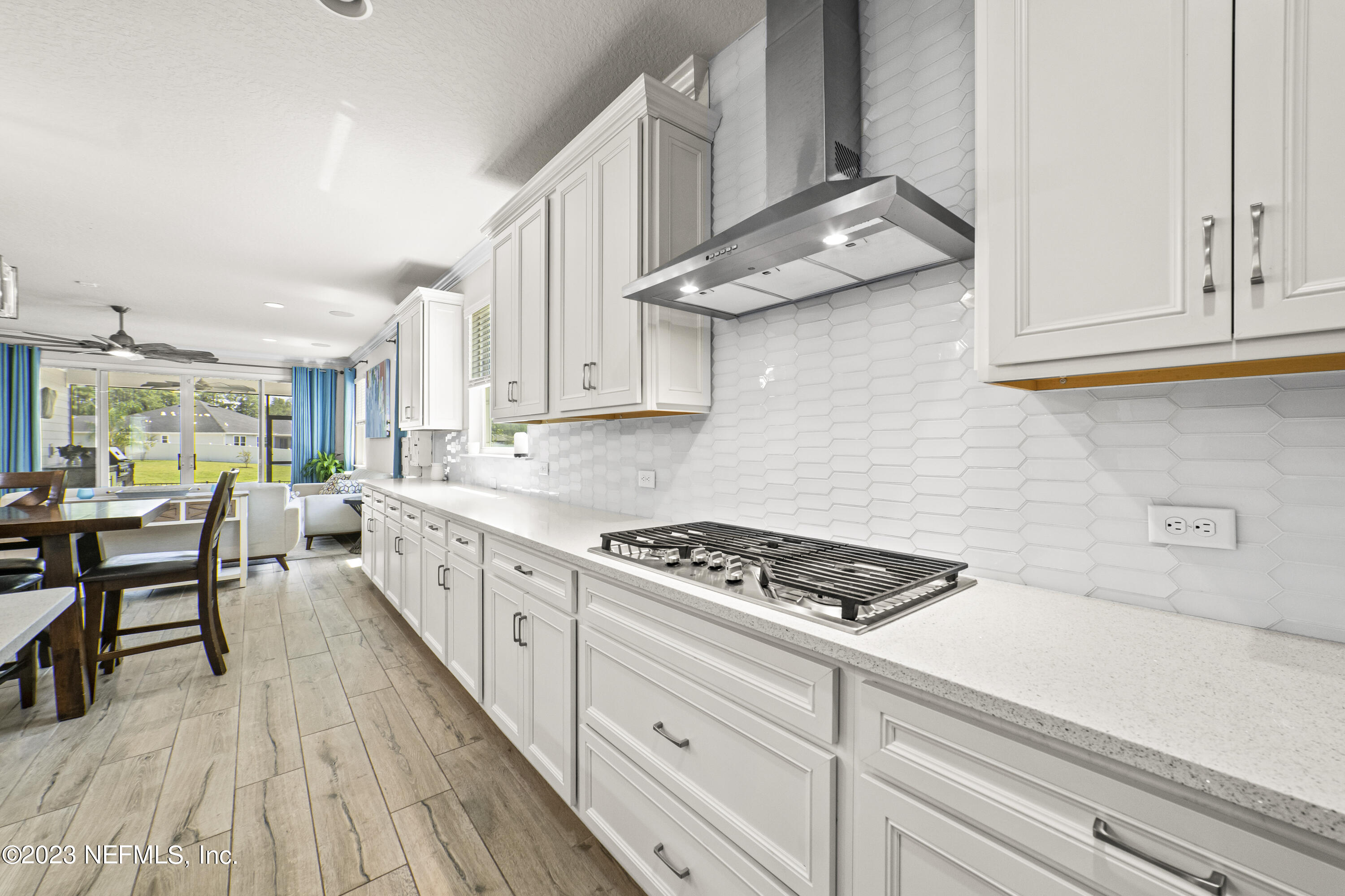 855 Flach Drive St. Johns, FL 32259 - Photo 10 of 50 a kitchen with granite countertop a stove a sink dishwasher and cabinets with wooden floor