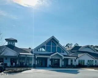 a view of house with a yard