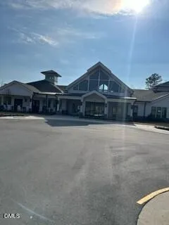 a view of swimming pool with a lawn chairs and palm trees