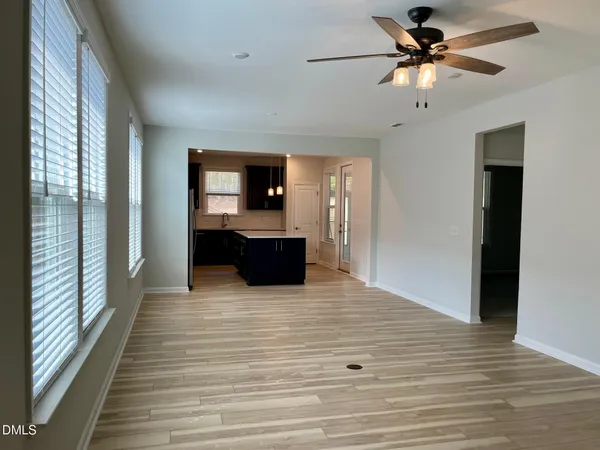 a view of kitchen with granite countertop cabinets and flat screen tv