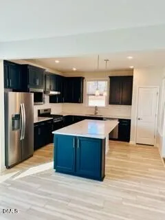 a kitchen with stainless steel appliances wooden cabinets a sink and a stove