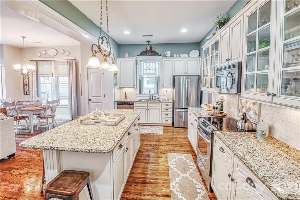 3547 Richard's Crossing Fort Mill, SC 29708 - Photo 6 of 41 a large kitchen with granite countertop a sink and dishwasher stove refrigerator a dining table