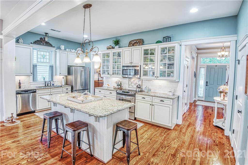 3547 Richard's Crossing Fort Mill, SC 29708 - Photo 7 of 41 a kitchen with center island wooden floor and stainless steel appliances