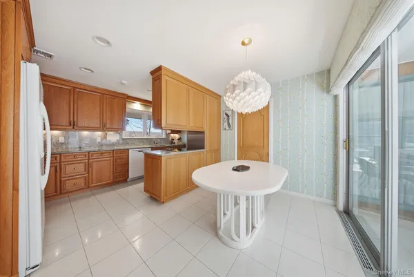 a large kitchen with granite countertop a sink