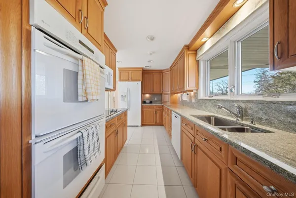 a kitchen with stainless steel appliances granite countertop a stove and a refrigerator