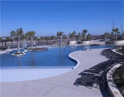 a terrace with wooden floor table and chairs