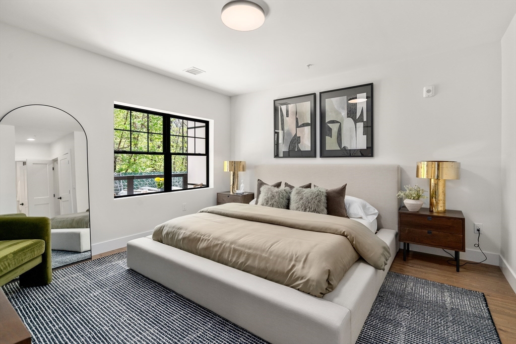 20 Audubon Way, Unit 408 Canton, MA 02021 - Photo 12 of 22 a living room with a bed furniture and a window