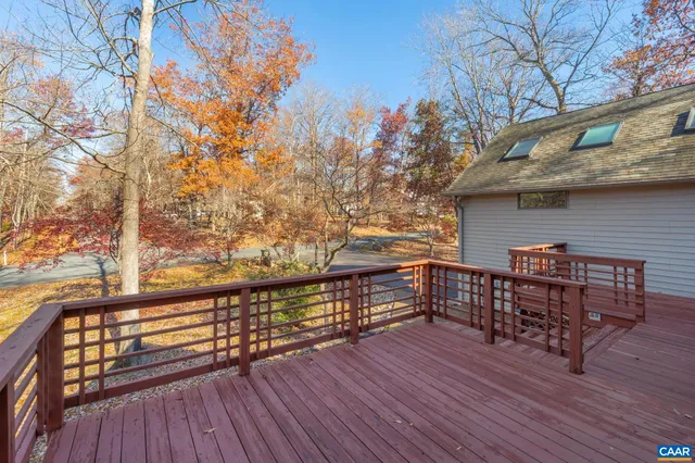 a balcony with wooden floor and bench