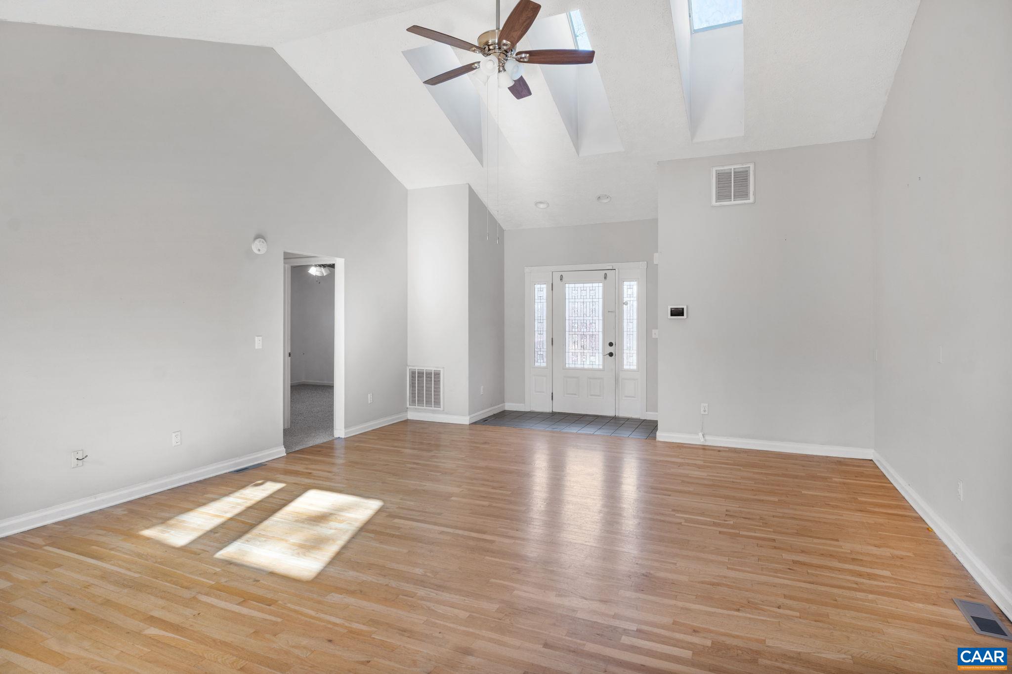 30 Colonial Road Palmyra, VA 22963 - Photo 6 of 30 a view of an empty room with wooden floor and a ceiling fan