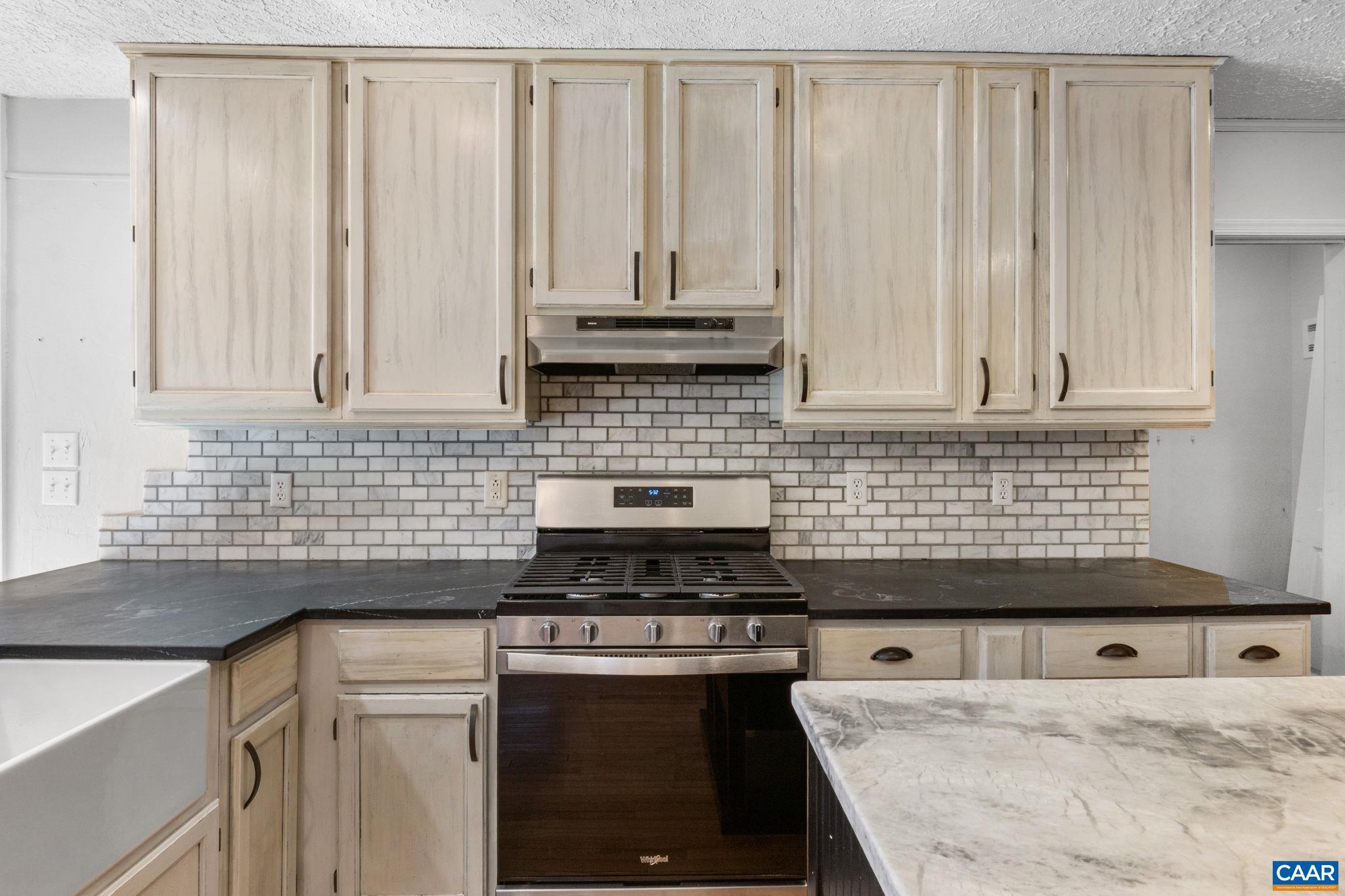 30 Colonial Road Palmyra, VA 22963 - Photo 10 of 30 a kitchen with granite countertop a sink a stove and cabinets