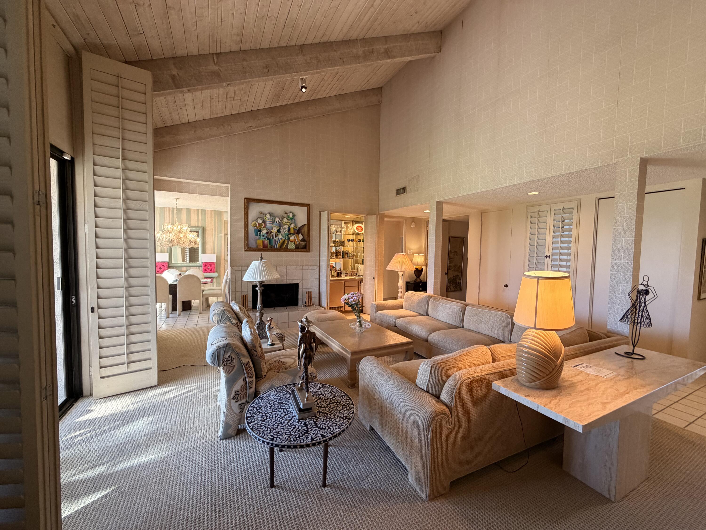 714 Inverness Drive Rancho Mirage, CA 92270 - Photo 3 of 16 a living room with furniture a fireplace and a flat screen tv
