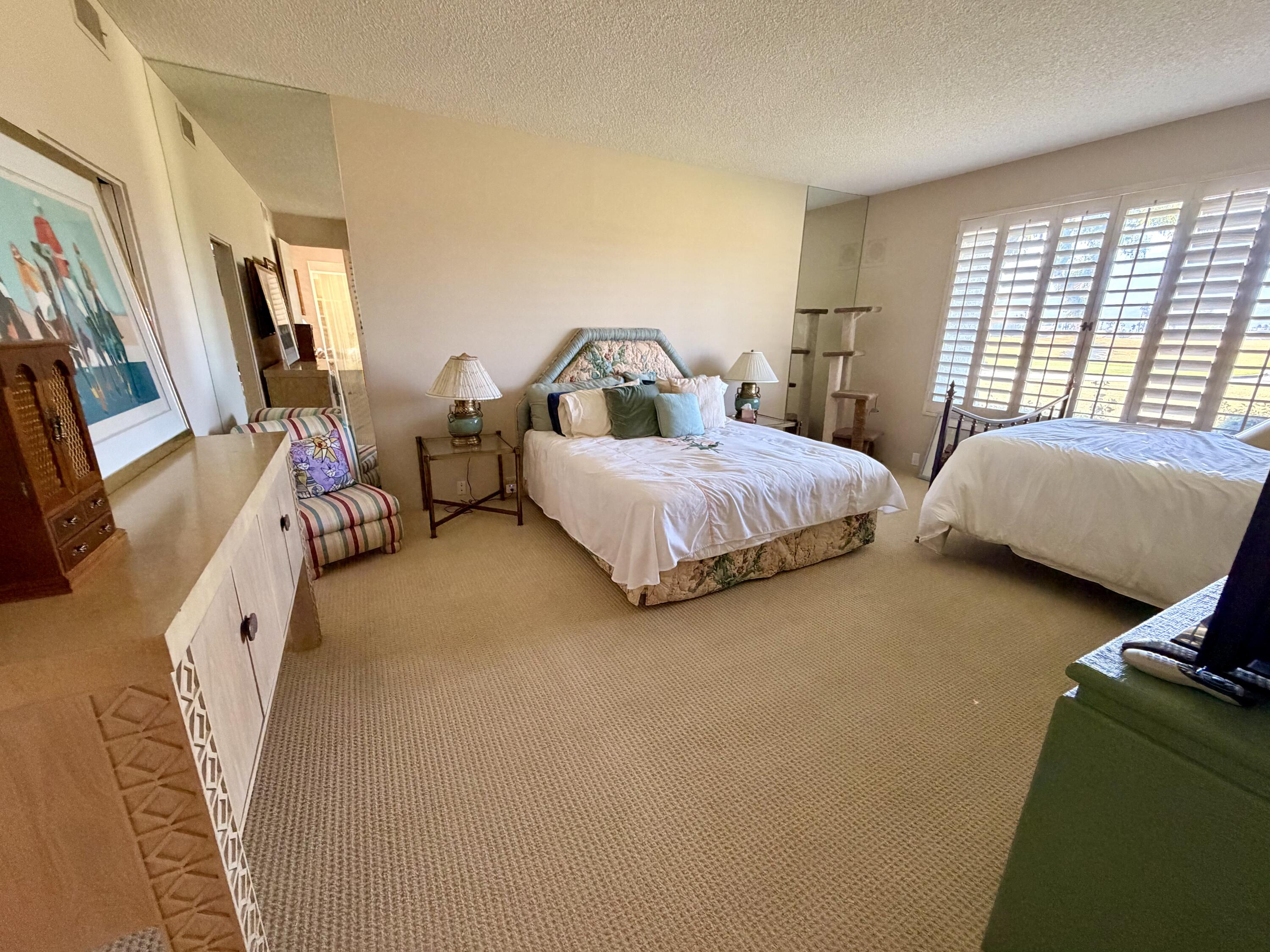 714 Inverness Drive Rancho Mirage, CA 92270 - Photo 9 of 16 a spacious bedroom with a bed and a window
