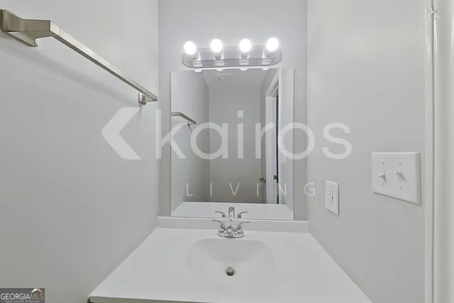 a bathroom with a sink vanity and a mirror