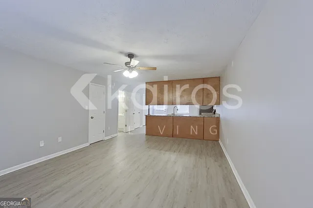 a view of a room with wooden floor and chandelier