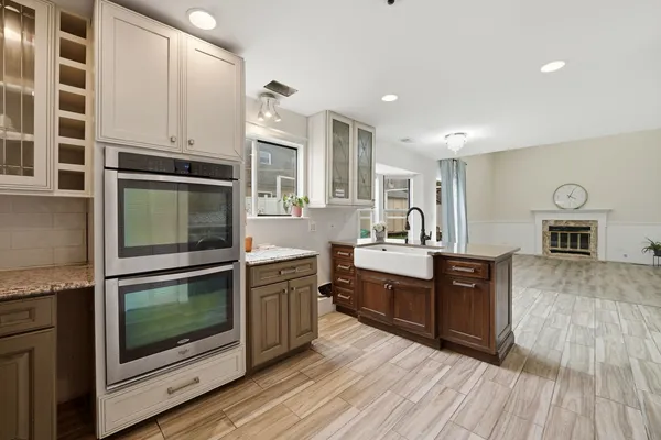 a kitchen with stainless steel appliances kitchen island granite countertop a stove a sink and a microwave
