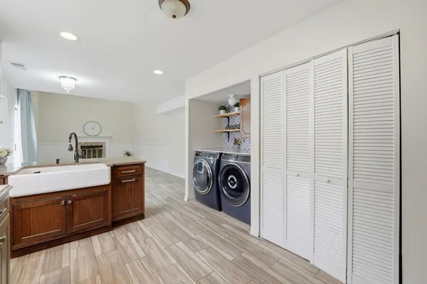 a room with a washing machine and a sink
